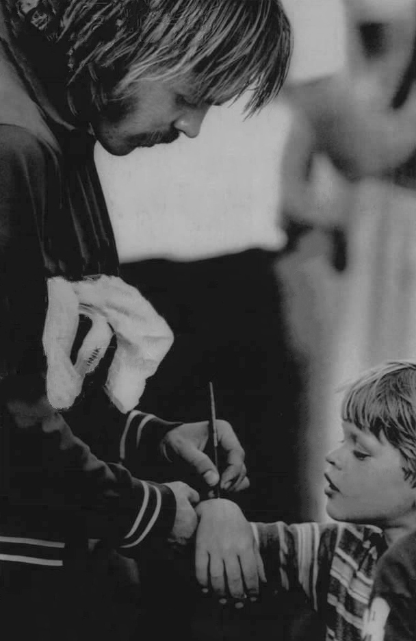 Steve Prefontaine signing an autograph for a young fan, 1975